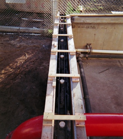 Plant repairs of their containment tank walls.<br>Formwork shows sacrificial anodes and treated rebar.